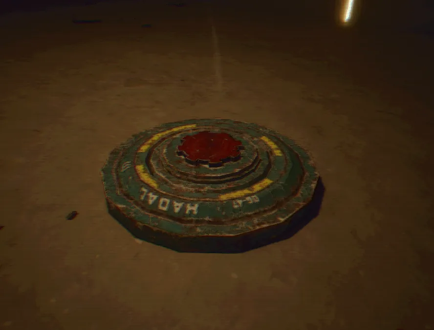 A Hadal landmine half-buried in a sandy floor, a red trigger in its centre.